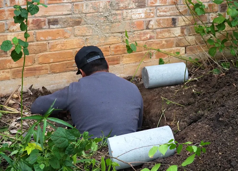 Concrete pier set beneath the footing of a Pflugerville home during underpinning